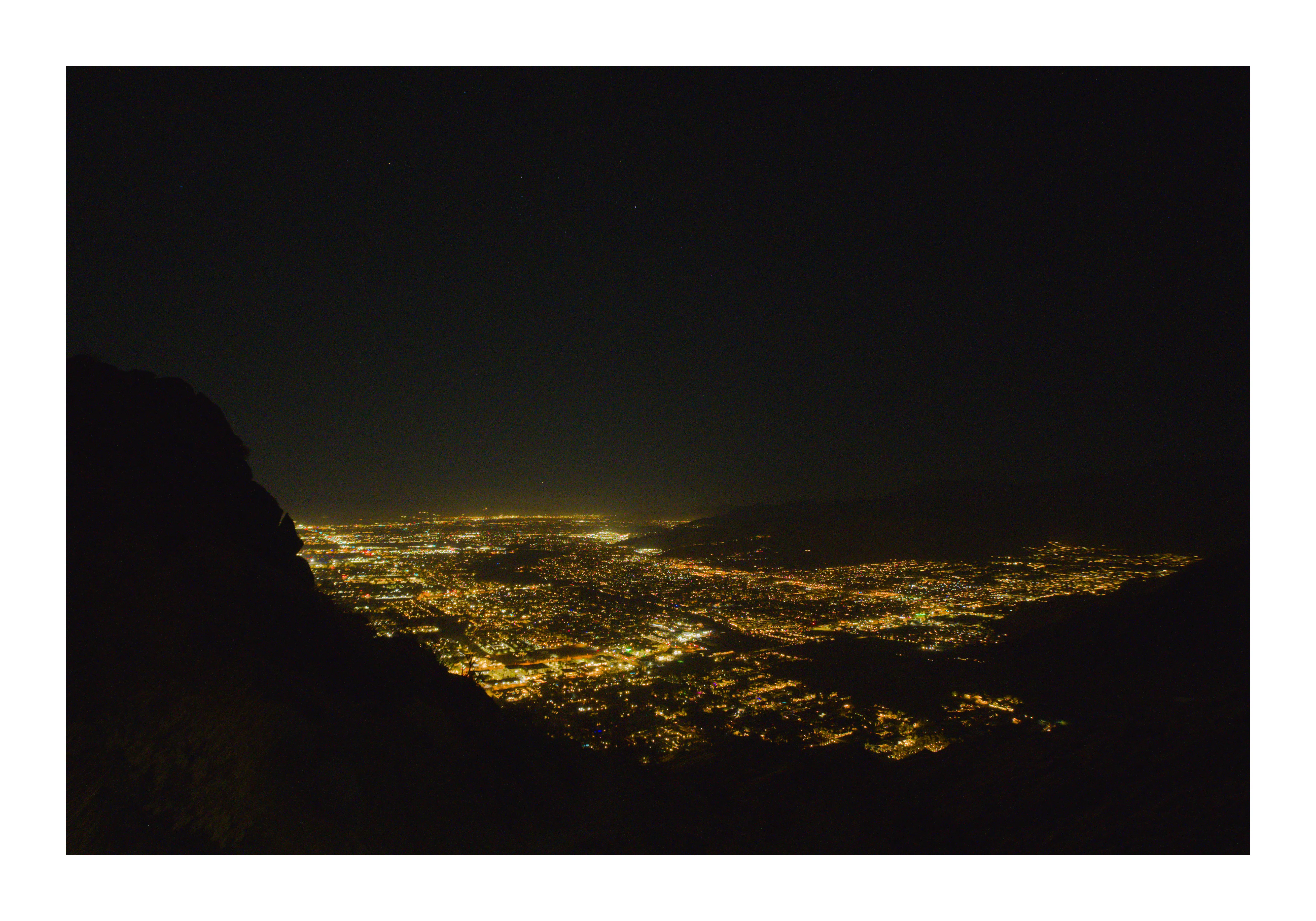 Hiking the trail before dawn by headlamp, the city lights of Palm Springs far below