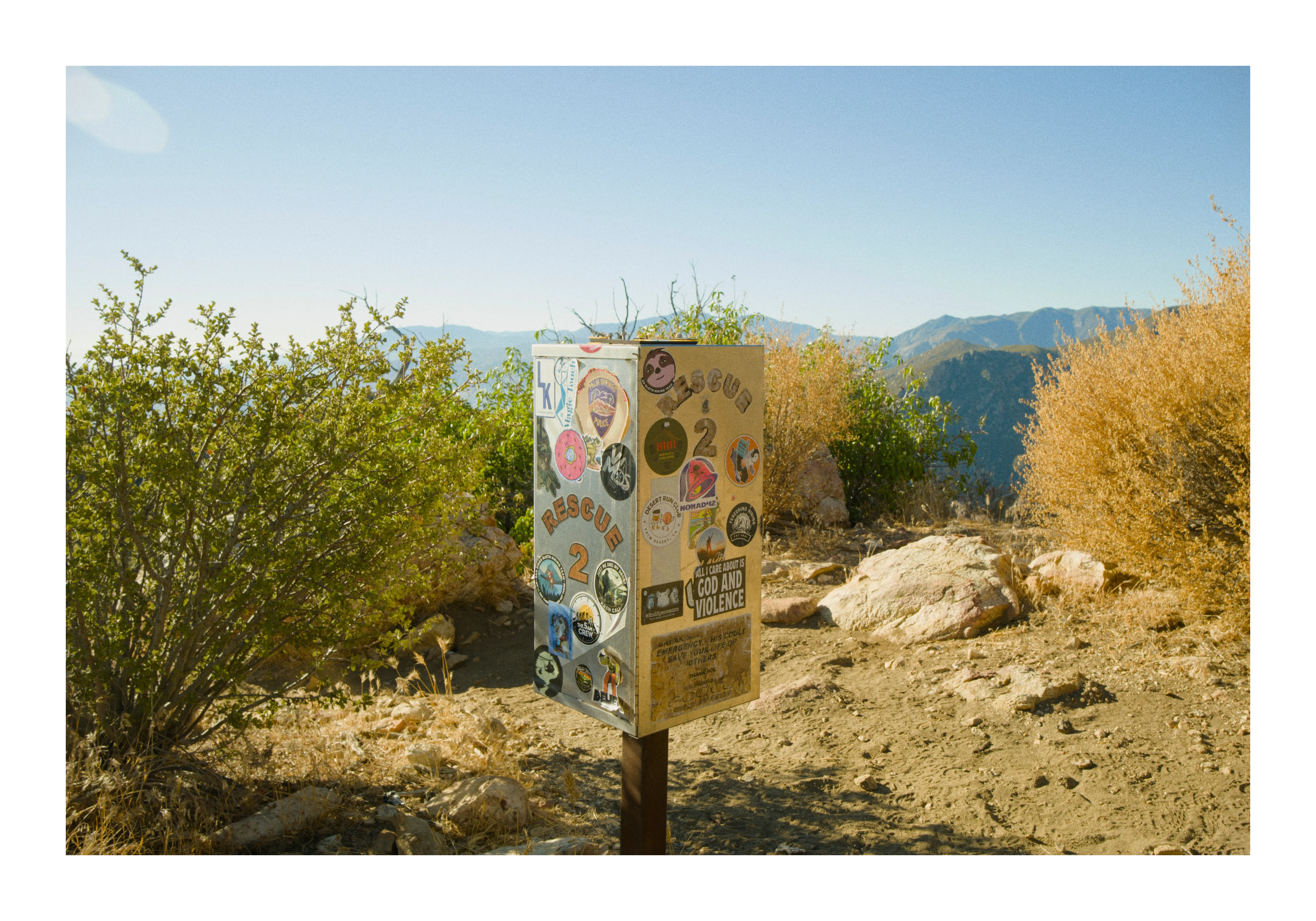 The second trailside help box, mostly empty, with the summit and the tram finally visible beyond it